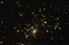 Hubble Sees Galaxy Cluster Warping Space and Time